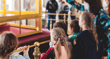Children stare inquisitively on a school field trip